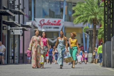 Group of women walking through Disney Springs with shopping bags