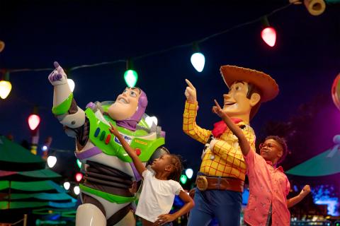Two boys pointing with Toy Story Characters Buzz Lightyear and Woody