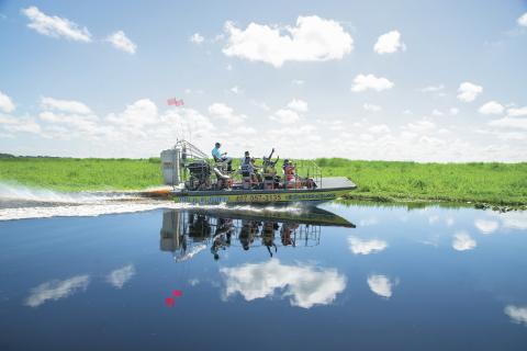 An airboat glides over the water at Wild Florida outdoor adventure park in Kissimmee