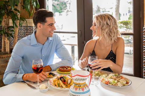 couple smiling at eachother dining at Columbia Resturant