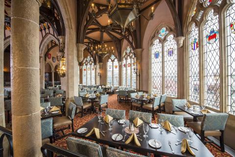 Landscape photo of inside a restaurant with glass windows at Magic Kingdom Park.