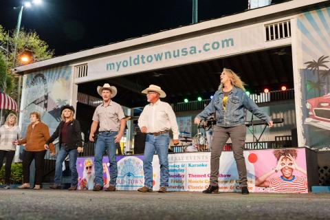 Six adults singing at Old Town Kissimmee.