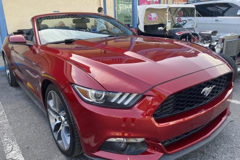 Red Mustang car parked at Old Town Kissimmee. 