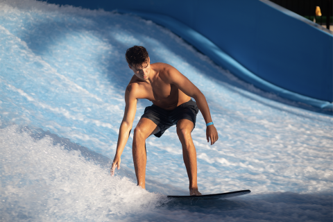 Boy surfing a wave at Gaylord Palms Resort and Convention Center.