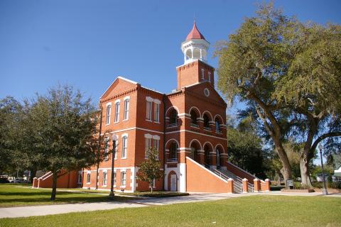 Large brick building on a grassy lawn in Downtown Kissimmee.