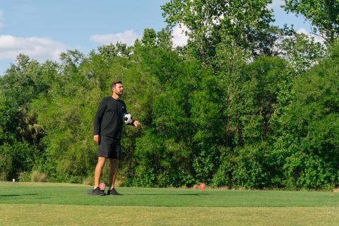 Luke Boden preps to kick a soccer ball at reunion footgolf course.
