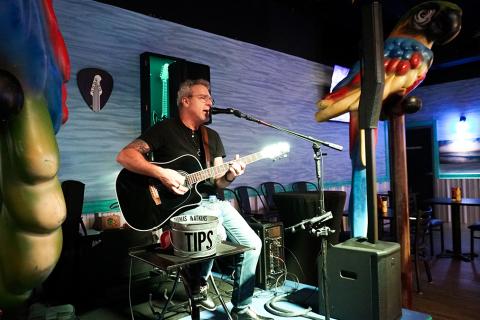 Man singing live music at Island Grill in St. Cloud.