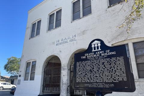 White building with historic sign outside in St. Cloud.
