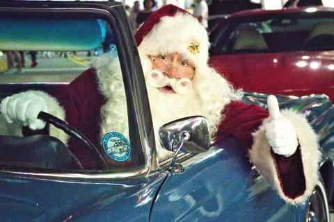 Santa driving a blue car at Promenade at Sunset Walk in Kissimmee.