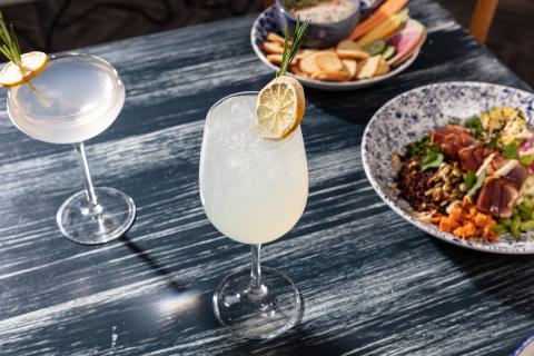 Mocktails with plates of food from Hampton Social.