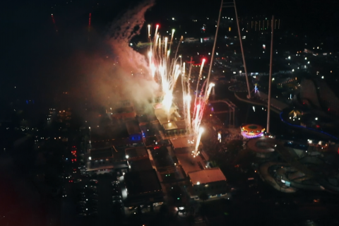 Aerial shot of fireworks coming from the tops of the buildings in Old Town Kissimmee.
