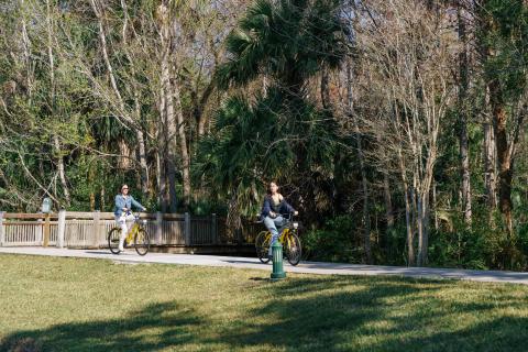 Samia and Jen Bonner riding bikes through Celebration.