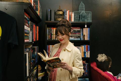 Keiko Lynn browses the books at Black Squirrel Bookstore and Speakeasy located inside Cloud 9 Marketplace.