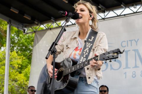 A musician performing on stage for Kissimmee’s annual birthday celebration, the Kowtown Festival.