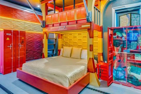 A brightly colored room with lots of reds, yellows, and robotic decor inspired by Iron Man.