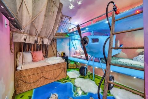 One of the bedrooms of High Flight features two bunk beds with an airplane and parachute motifs throughout.