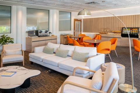 The Level Lounge is an open concept room with cozy chairs and couches and a snack bar with beverages.