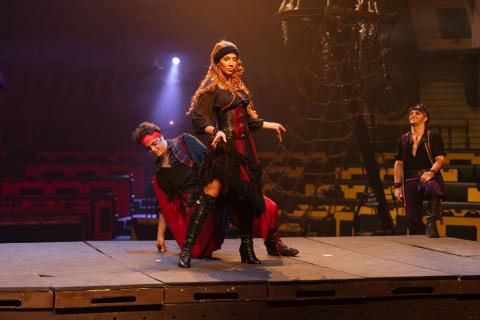 Chelsea Green, in full pirate costume, strikes a confident pose alongside a pirate performer at Pirates Dinner Adventure.