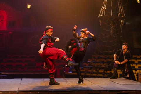 Chelsea Green delivers a high kick on stage at Pirates Dinner Adventure in Kissimmee during a playful stunt with one of the performers.