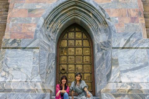 Yvette Young and Jen Bonner sit on the steps in front of Bok Tower’s grand stone entrance.