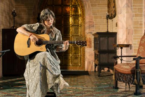 Yvette Young sits inside the Bok Tower carillon chamber, playing her guitar.