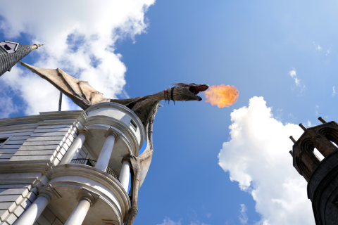 A look up at the fire-breathing dragon sitting at the top of Gringotts Bank at Universal Studios Florida.