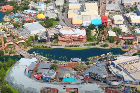 Aerial view of Universal CityWalk and the surrounding attractions at Universal Orlando Resort, including Hard Rock Café, lagoon walkways, and nearby theme park areas.
