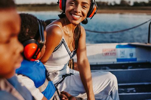 Woman and two boys sitting on airboat in Kissimmee.