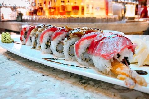a close up view of a plate of sushi sits on a counter. 