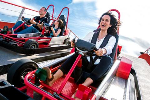 A woman rides a go-cart.