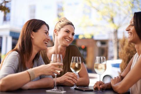 Women enjoying a glass of wine.