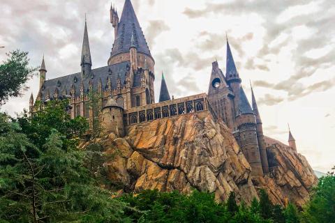 View of the Hogwarts Castle attraction perched on a rocky hillside at Universal’s Islands of Adventure in Orlando, Florida.