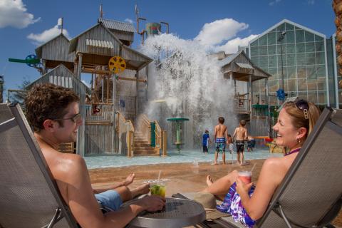 A couple relaxes poolside at Gaylord Palms Resort.