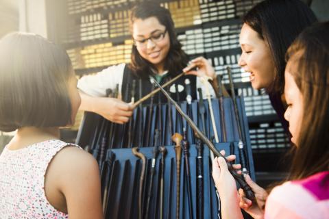 Young girls browse their wands at the Wizarding World of Harry Potter at Universal Orlando Resort.