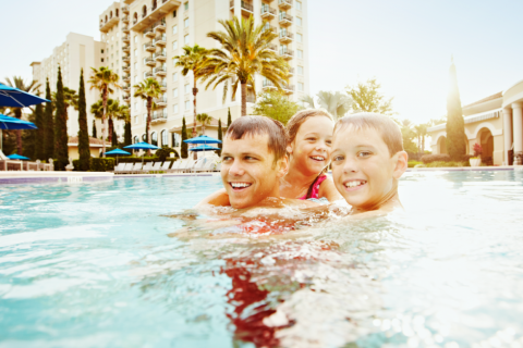 man and two children playing in the Omni Orlando Resort pool 