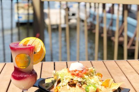 Cocktail and plate of nachos on an outdoor table at Paradiso 37 in Disney Springs