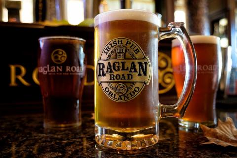 Branded glasses of Raglan Road™ Irish Pub and Restaurant signature beer on the bar