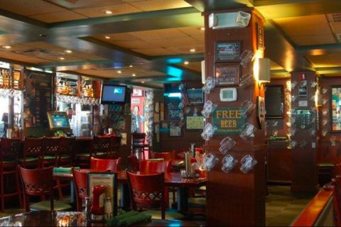 Interior of Celebration Town Tavern in Celebration, Florida, featuring warm lighting, wooden furniture, and classic pub décor with beer mugs and sports memorabilia.