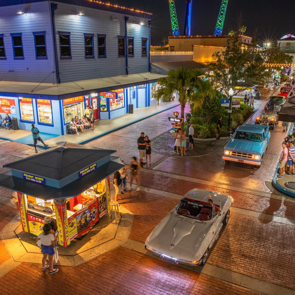 Old Town main street at night with lighted cars and buildings
