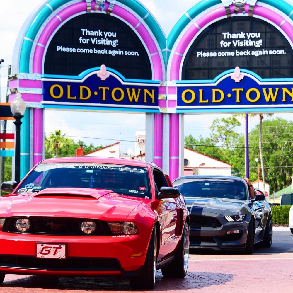 Red Mustang on display during a car show at Old Town Kissimmee