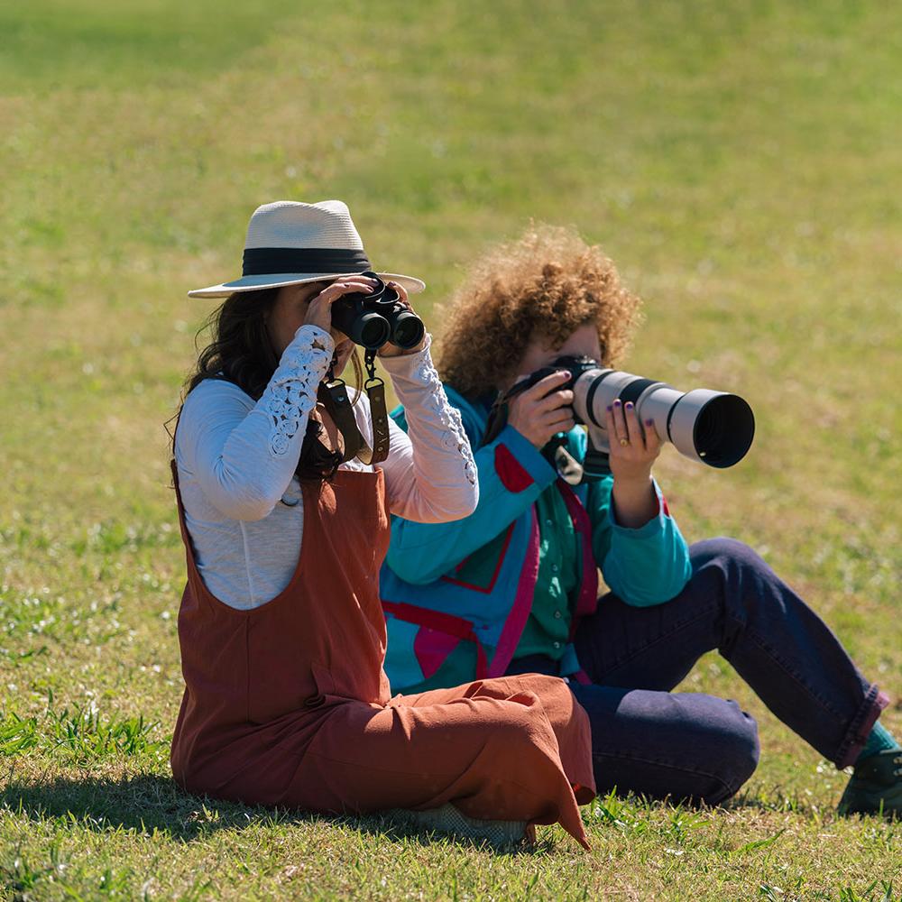 Carla Rhodes and Jen Bonner birdwatch with a long-lens camera at Omni Resort.
