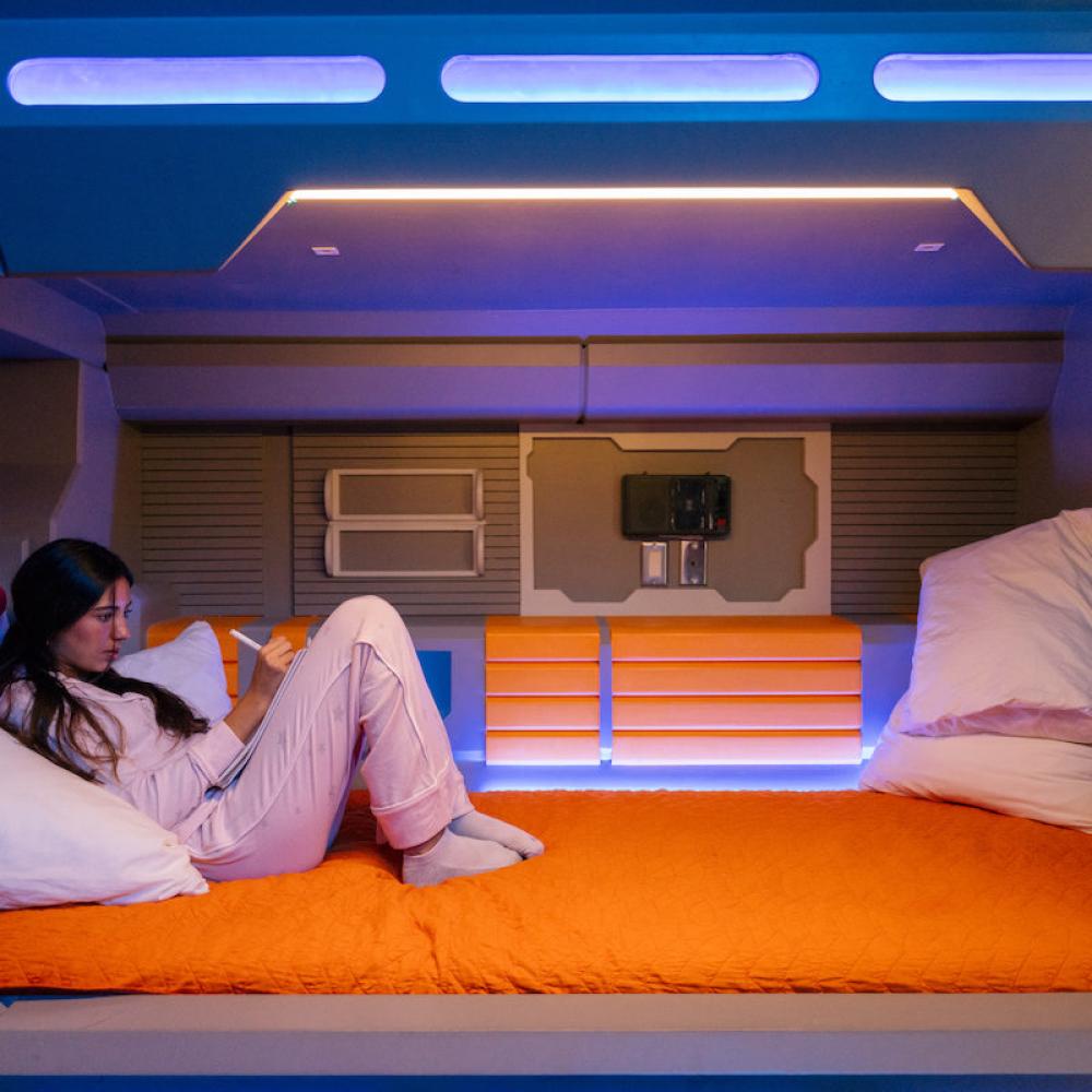 Girl sitting in a rocket ship bed at a Kissimmee vacation home.