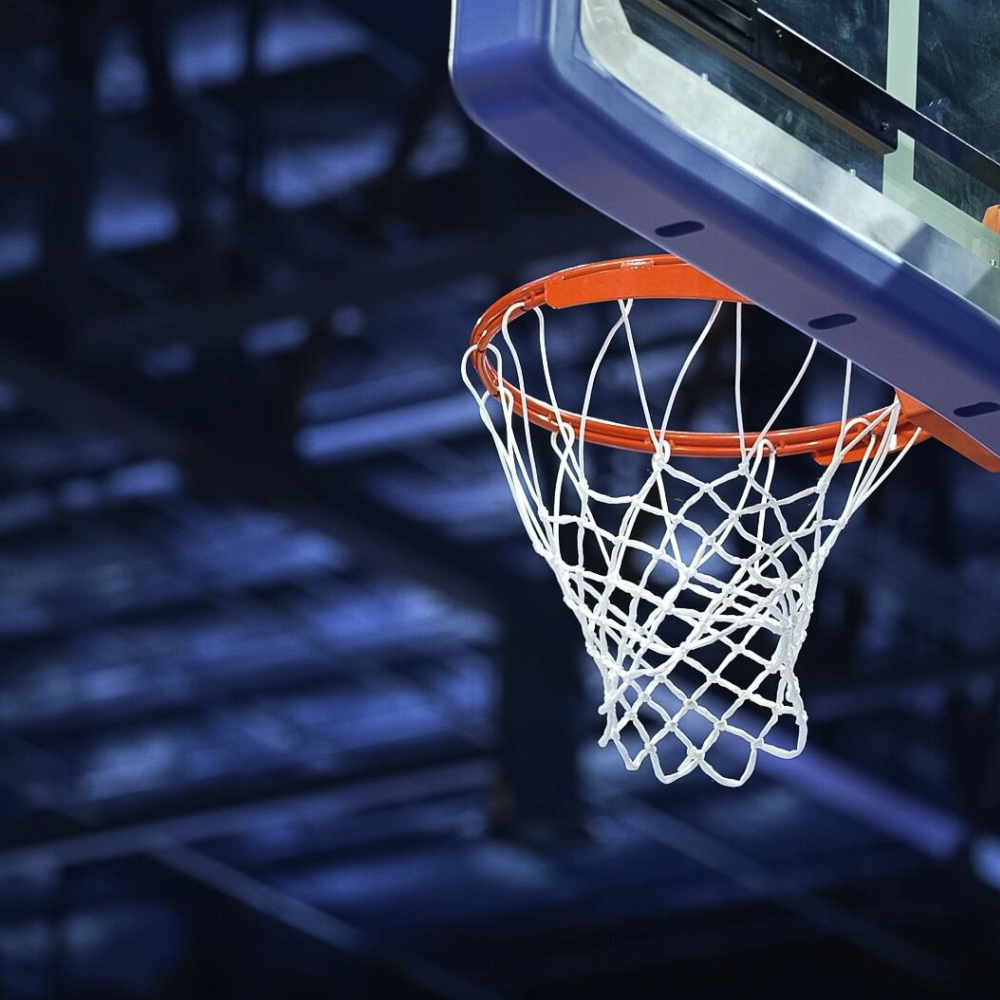A close up of a basketball hoop in a stadium. 