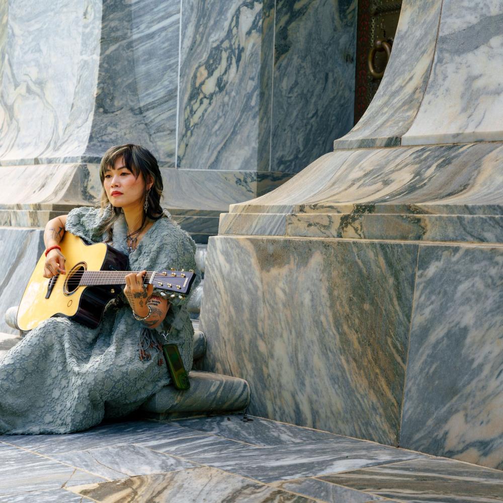 Yvette Young sits outside Bok Tower, preparing some music for her performance inside the historic tower.
