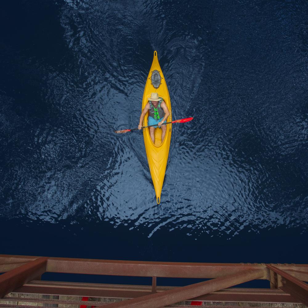 aerial shot from above of man in kayak