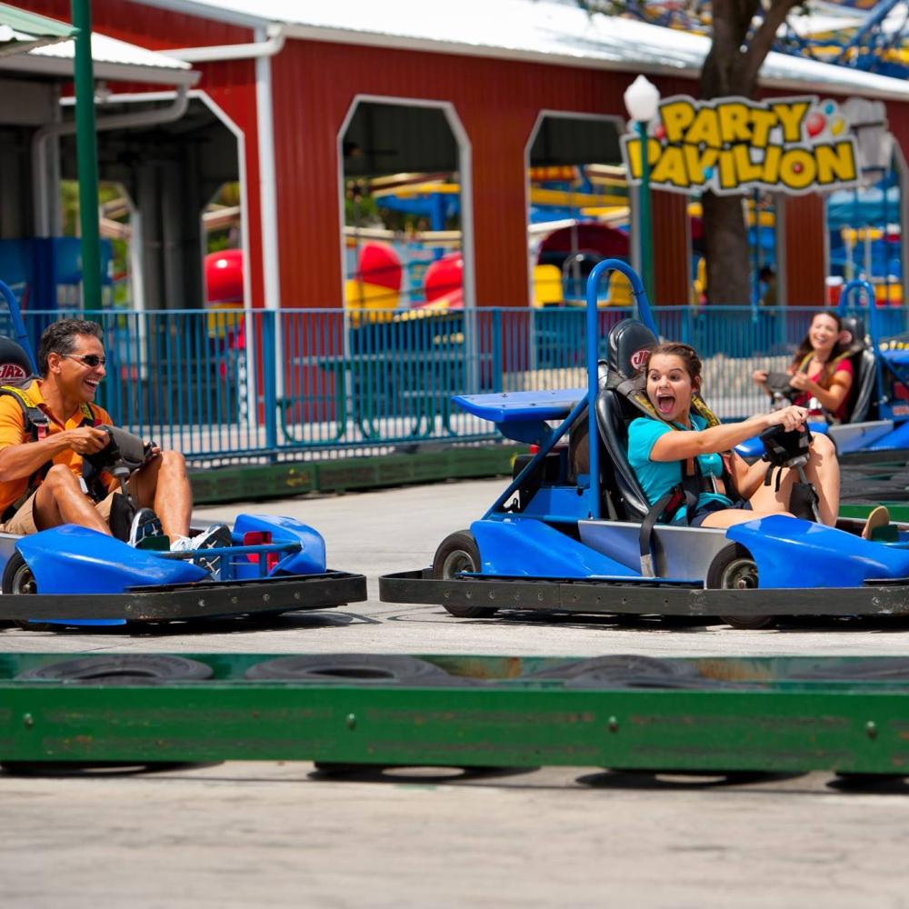 A father and her daughter race around a Go Kart track in Kissimmee, Florida.