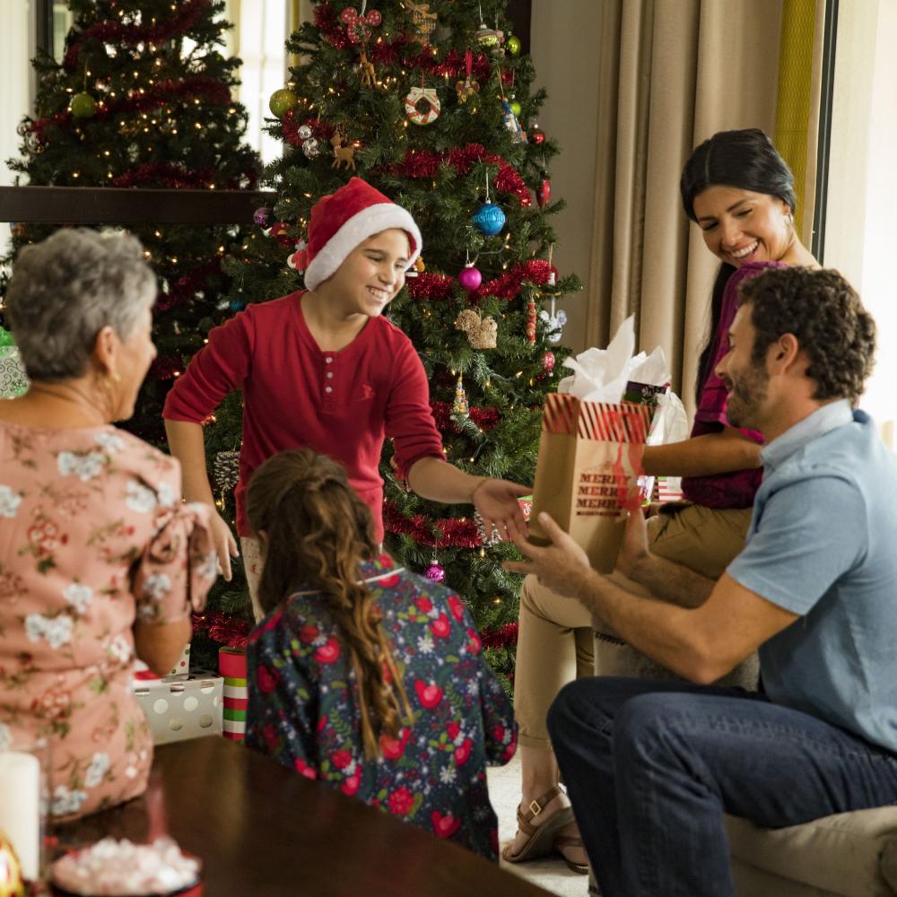 A large family gathers around the Christmas tree in Kissimmee