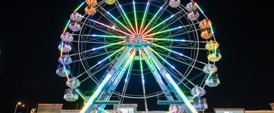 Night photo of the lit-up ferris wheel at Old Town Kissimmee.