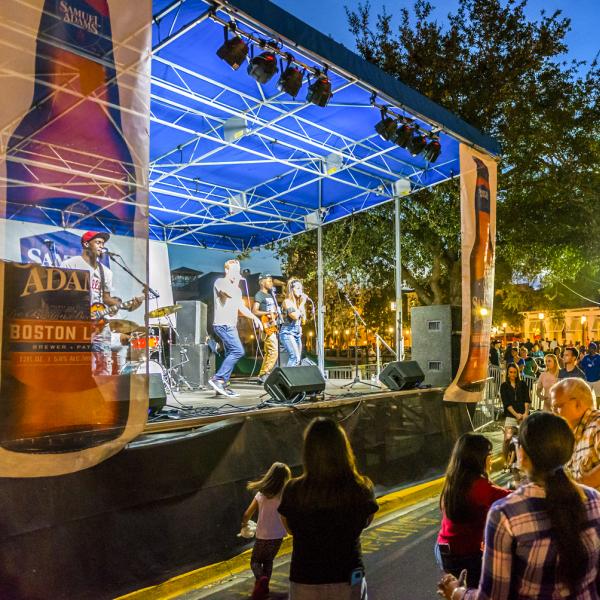 music group performing in front of a crowd outdoors at the Fall Festival in Downtown Celebration