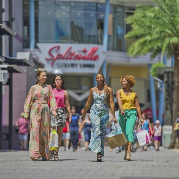 Group of women walking through Disney Springs with shopping bags